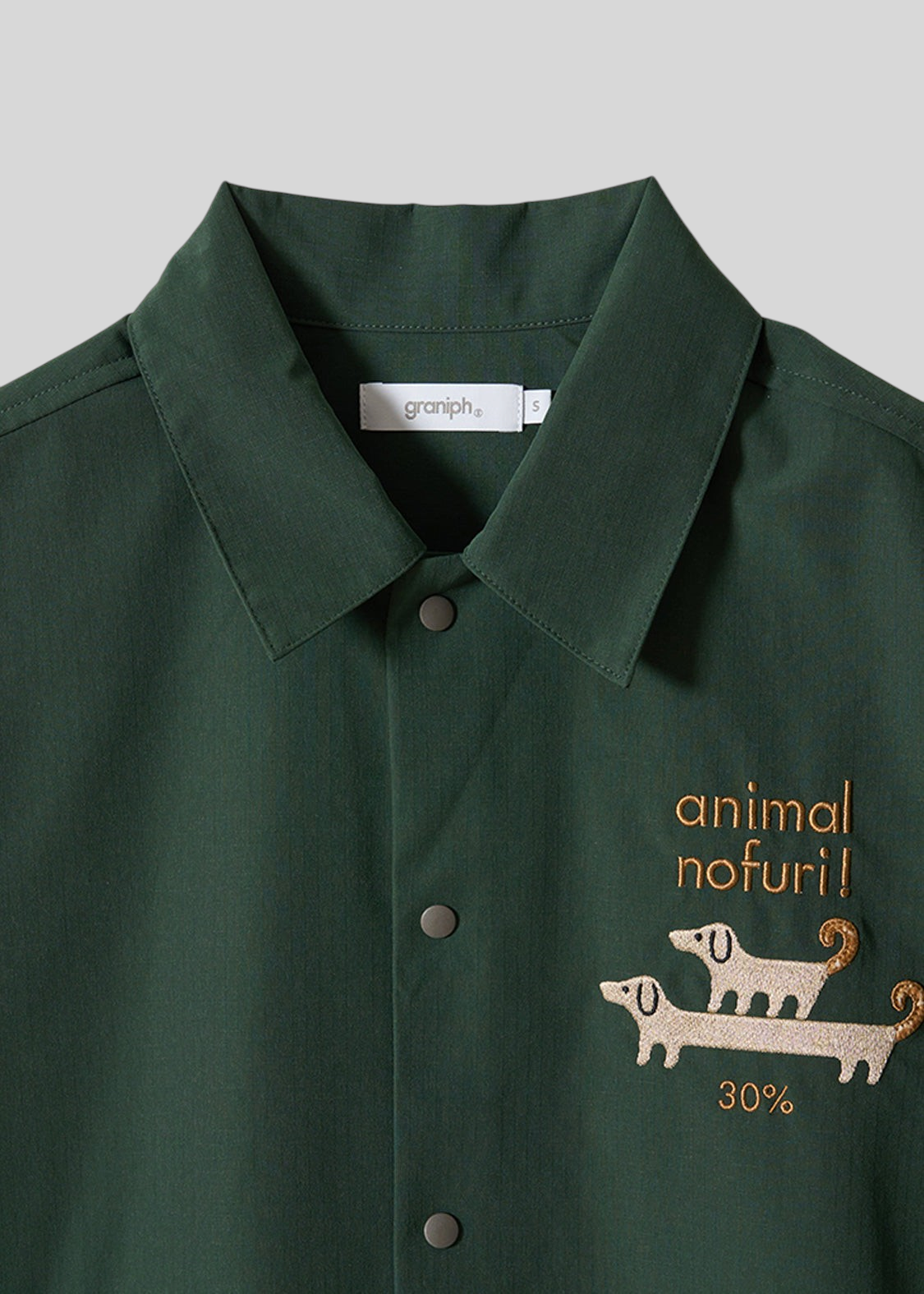 Via Artists dark green ripstop coach shirt featuring embroidered long-haired dog design and snap button closure