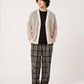Via Artists Ikaku Royal mesh knit V-neck cardigan in beige worn by a model over a black shirt and plaid trousers