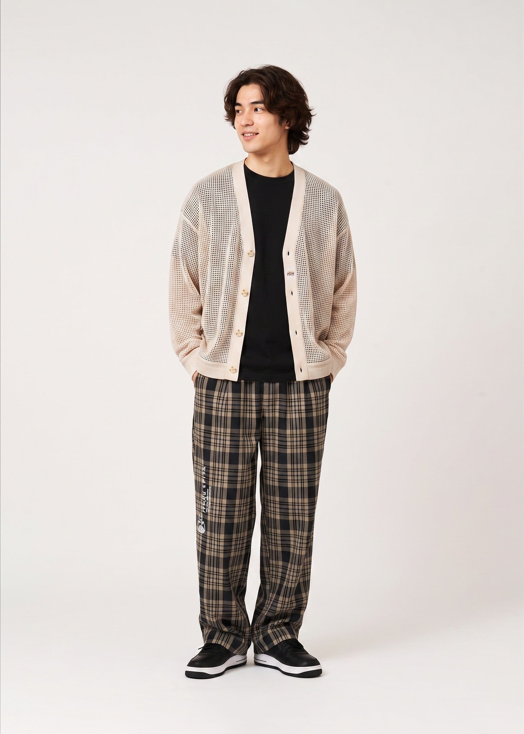 Via Artists Ikaku Royal mesh knit V-neck cardigan in beige worn by a model over a black shirt and plaid trousers