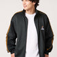 Via Artists Ikaku Royal black track jacket with gold sleeve tape and embroidered red panda graphic on a male model