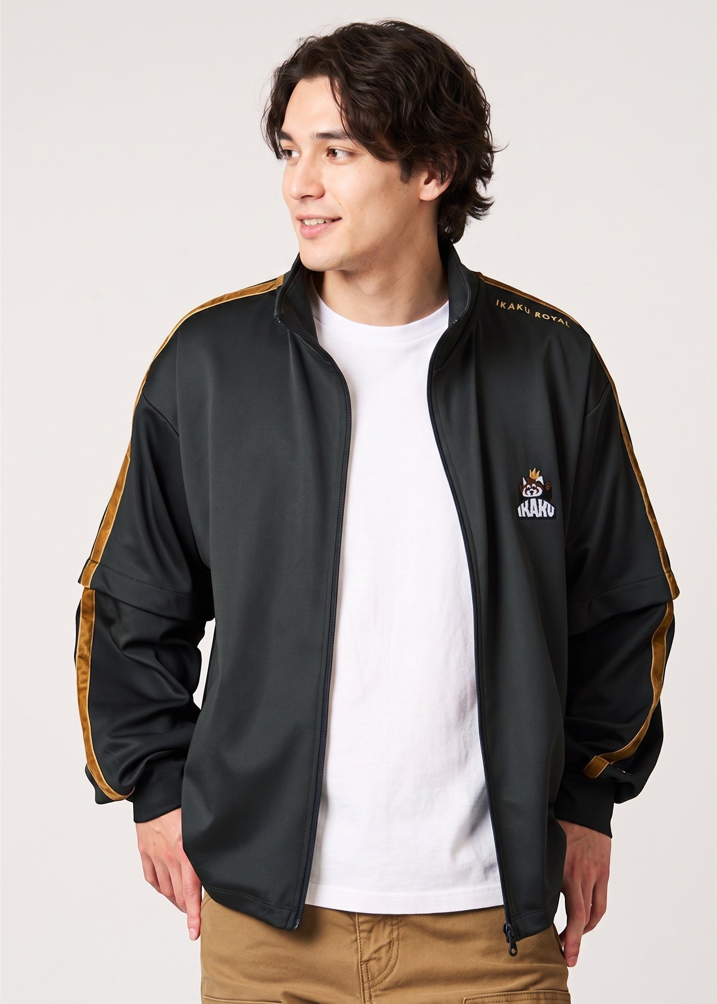 Via Artists Ikaku Royal black track jacket with gold sleeve tape and embroidered red panda graphic on a male model
