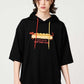 Via Artists black short-sleeve hoodie featuring a Nagasugiru Inu hot dog graphic and colorful drawstring cords