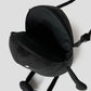 Via Artists Beautiful Shadow plush pouch in black with a zippered opening, long limbs, and a crossbody strap.