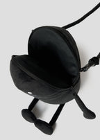 Via Artists Beautiful Shadow plush pouch in black with a zippered opening, long limbs, and a crossbody strap.