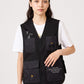 Via Artists black polyester vest with embroidered crown characters and front pockets worn by a female model
