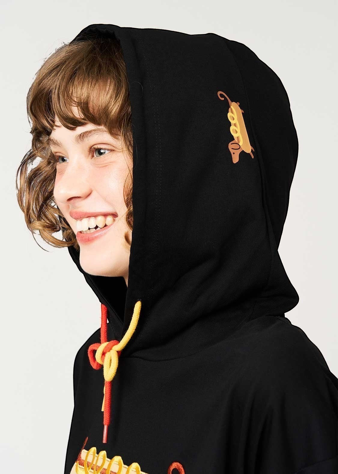 Via Artists black short-sleeve hoodie featuring a red panda embroidery on the hood and a colourful drawstring.