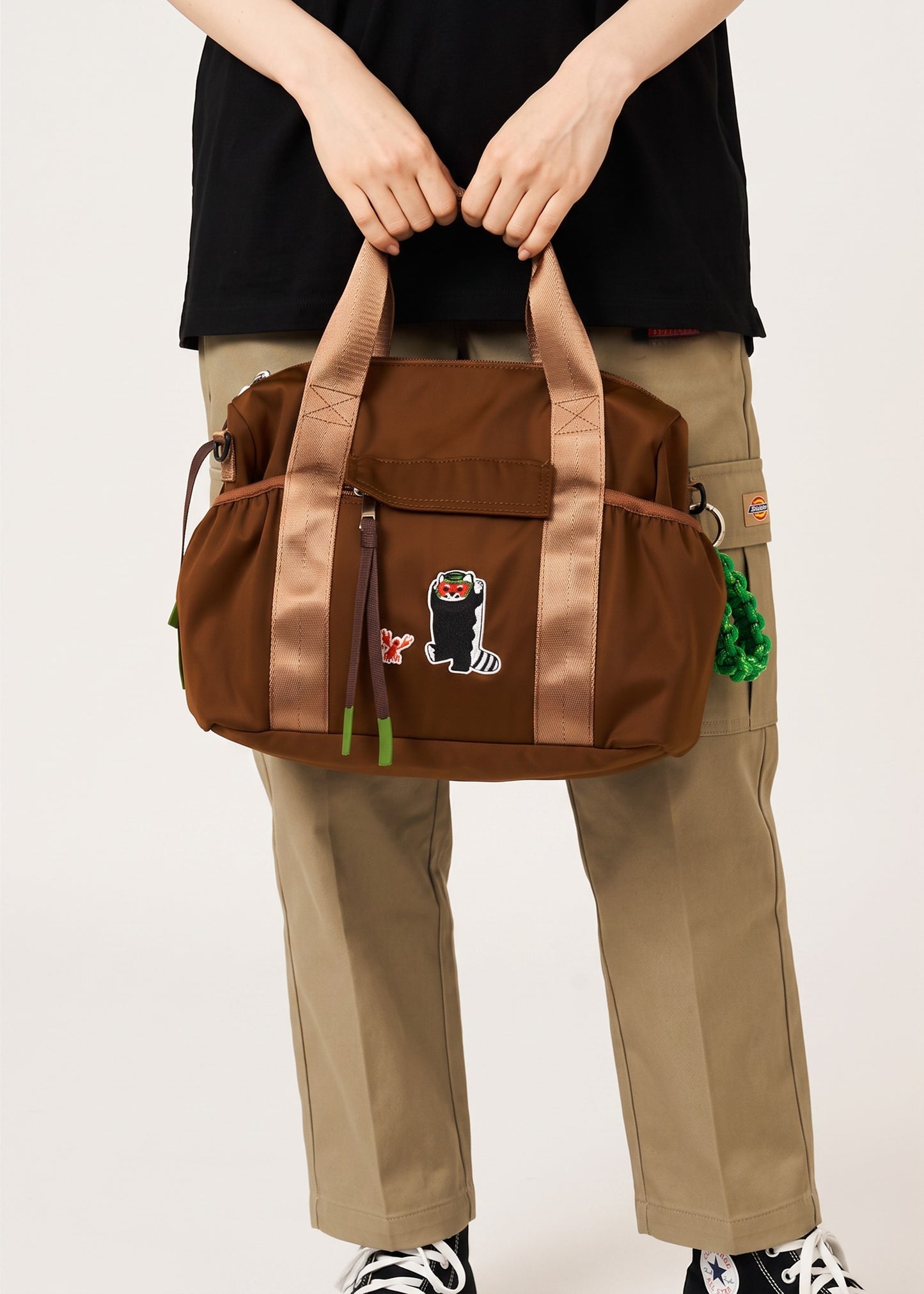 Via Artists Ikaku Lucha Boston shoulder bag in brown nylon with an embroidered red panda wrestler design
