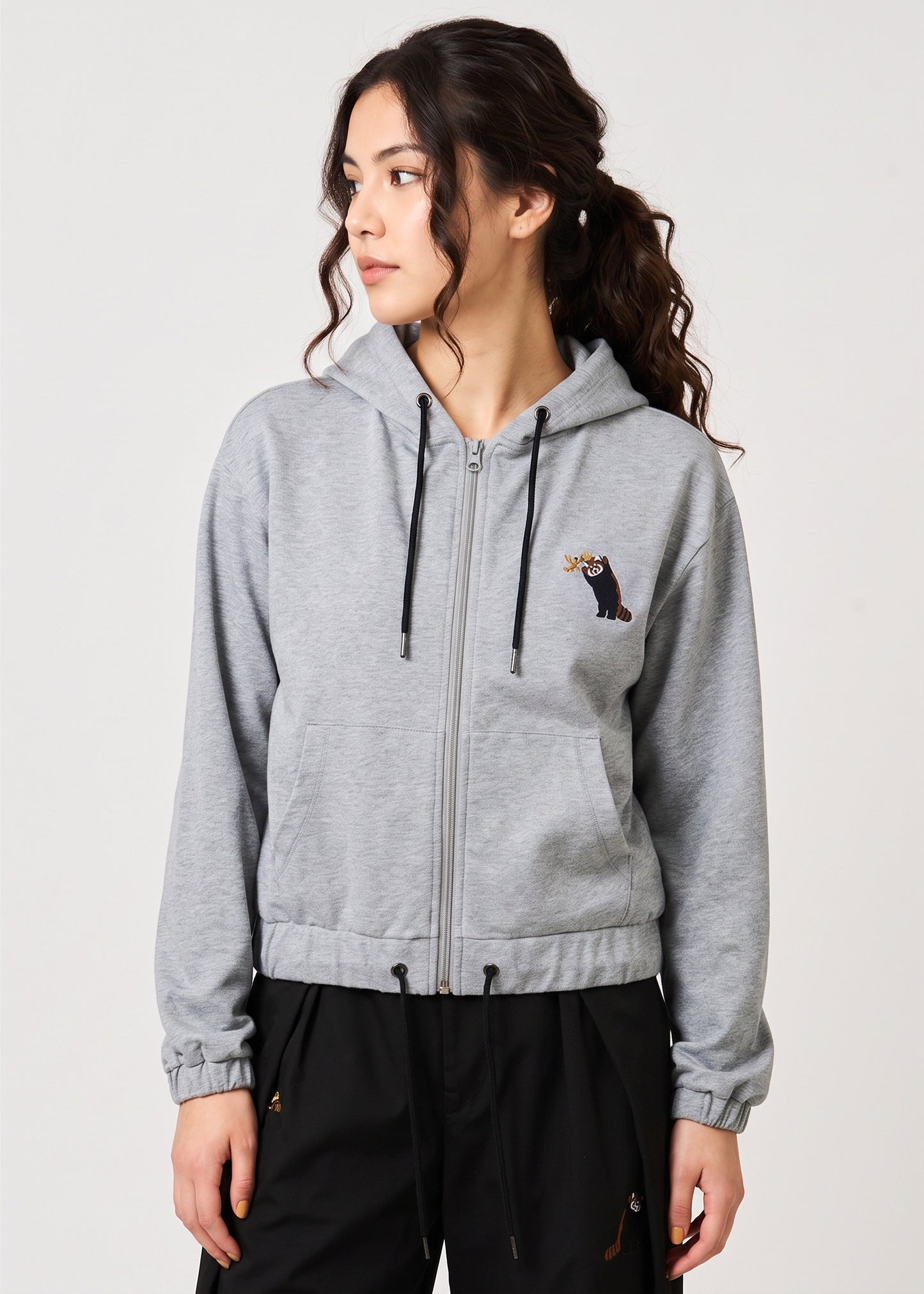 Via Artists royal grey zip hoodie with red panda embroidery worn by a woman with a rounded hem and soft cotton fabric