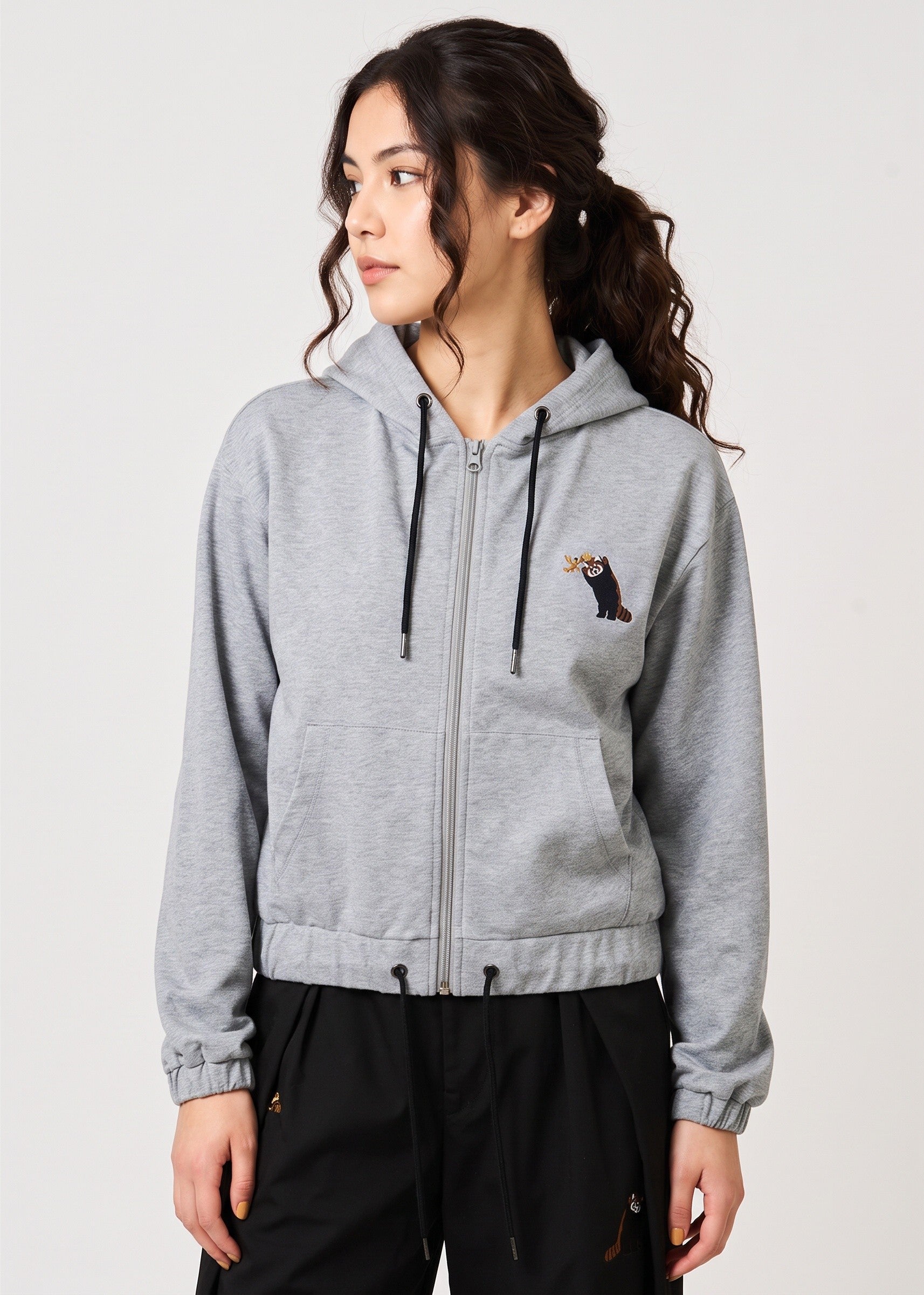 Via Artists royal grey zip hoodie with red panda embroidery worn by a woman with a rounded hem and soft cotton fabric