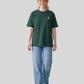 Via Artists Helcovell Rush oversized dark green cotton t-shirt worn by a woman with a baseball cap and blue jeans