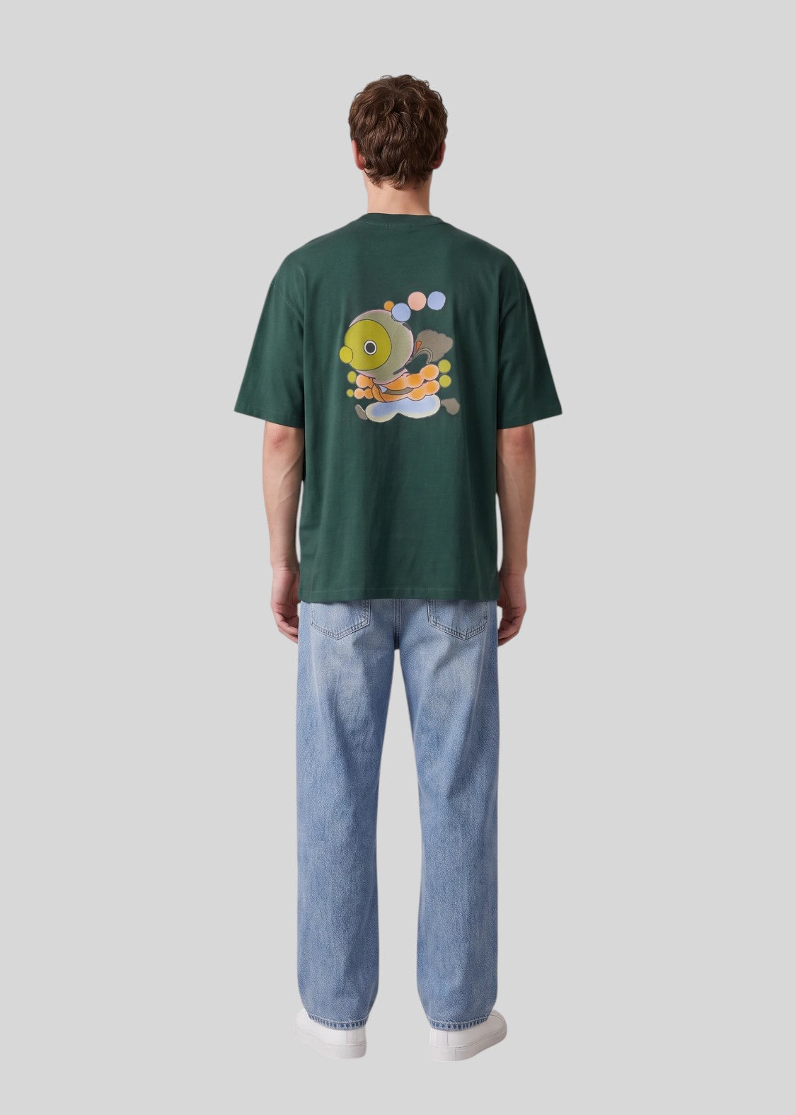 Via Artists Helcovell Rush oversized dark green cotton t-shirt with back graphic print worn by a man