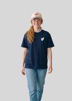 Via Artists Helcovell Sleepy beige cotton 6-panel baseball cap with pink heart embroidery worn by a smiling woman