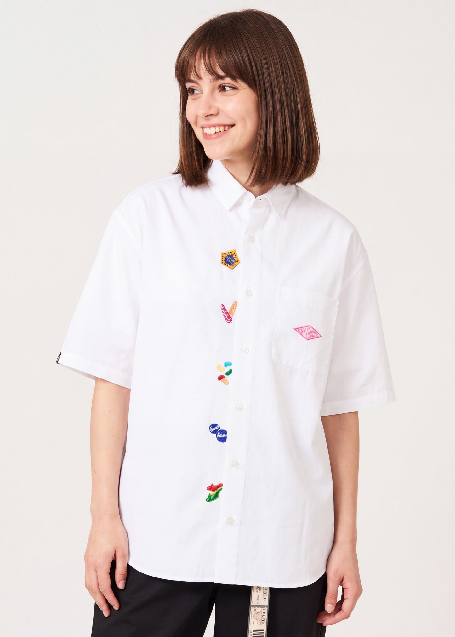 Via Artists white short-sleeved shirt with embroidered Harry Potter Honeydukes candy motifs and a relaxed fit