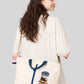 Via Artists Ikaku Goron 2-way cotton canvas tote bag with adjustable strap and embroidered graphic, worn over shoulder.