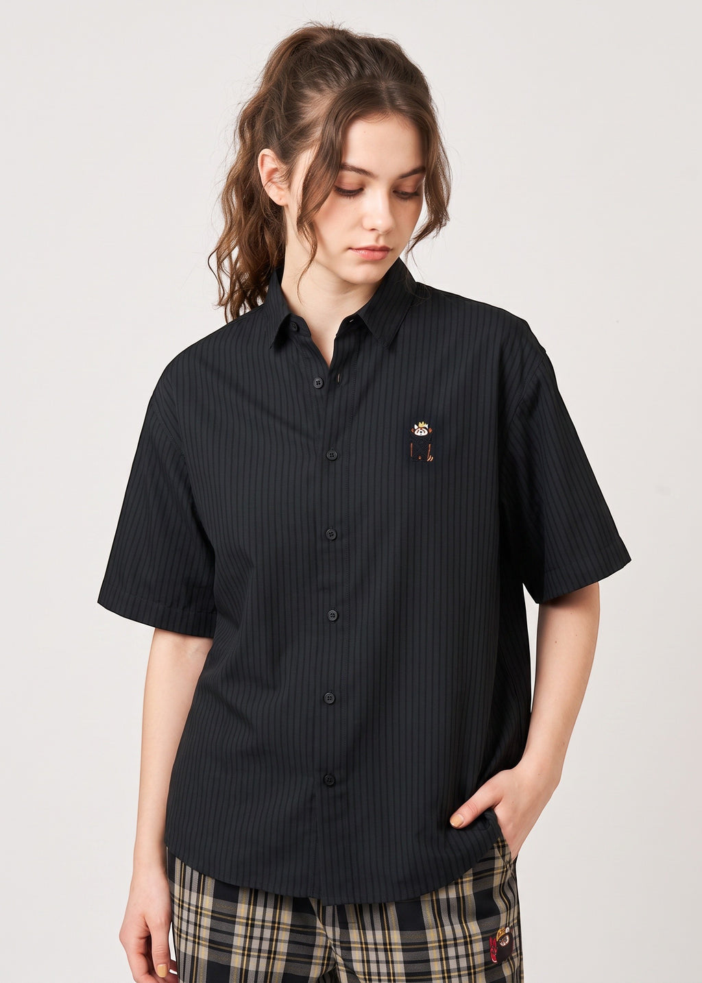 Via Artists Ikaku Royal black pinstriped short-sleeve shirt with red panda embroidery worn by a woman