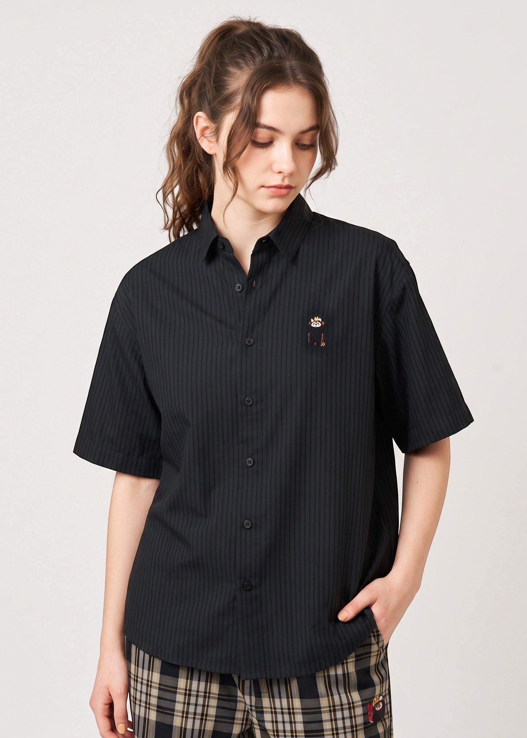 Via Artists Ikaku Royal black pinstriped short-sleeve shirt with red panda embroidery worn by a woman