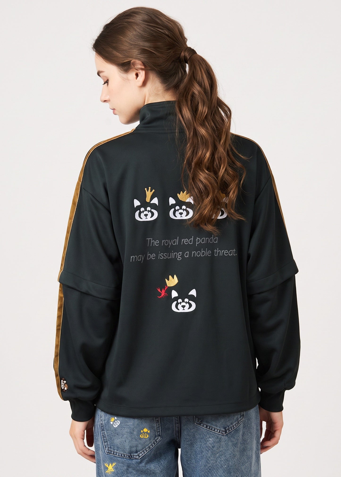 Via Artists Ikaku Royal black track jacket with red panda embroidery and detachable sleeves worn by a woman