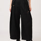 Via Artists Ikaku Royal DRK wide-leg pleated black pants with red panda embroidery, worn with a white top.