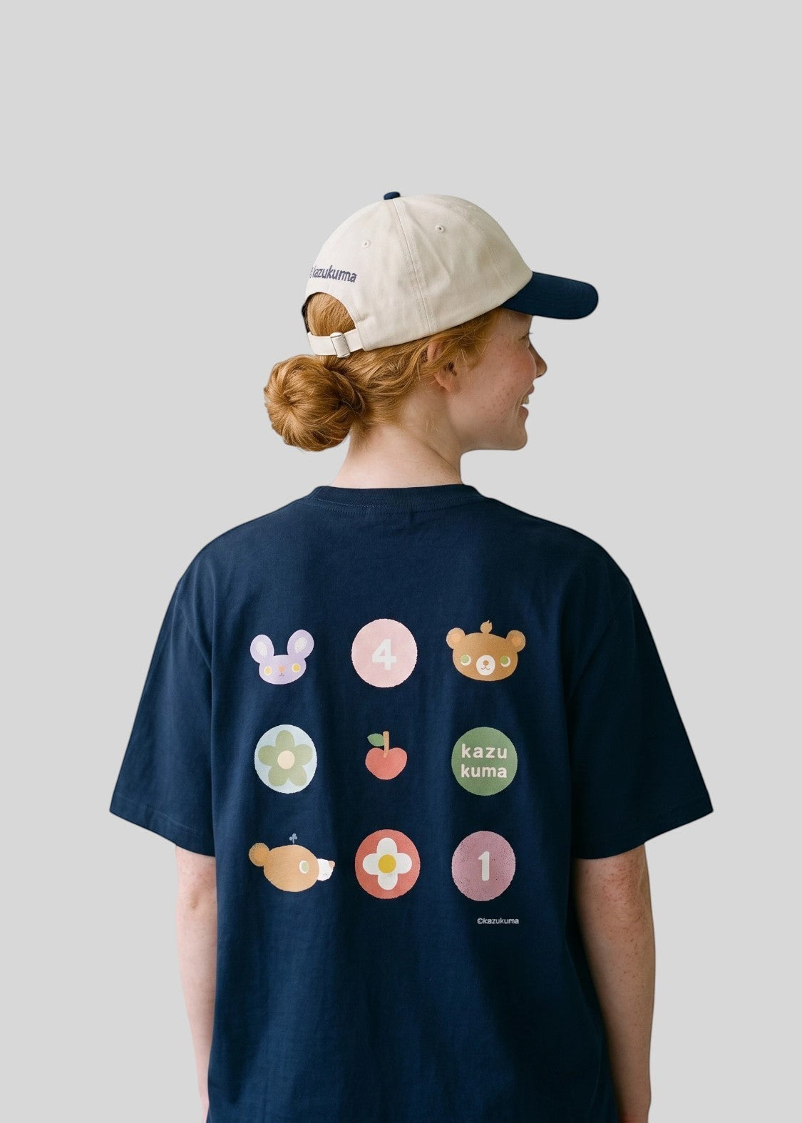 Via Artists Kazukuma Collage oversized navy cotton t-shirt with colorful graphic print on back worn by a woman