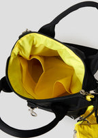 Via Artists Beautiful Shadow Lucha mini shoulder bag interior showing bright yellow lining and storage pockets