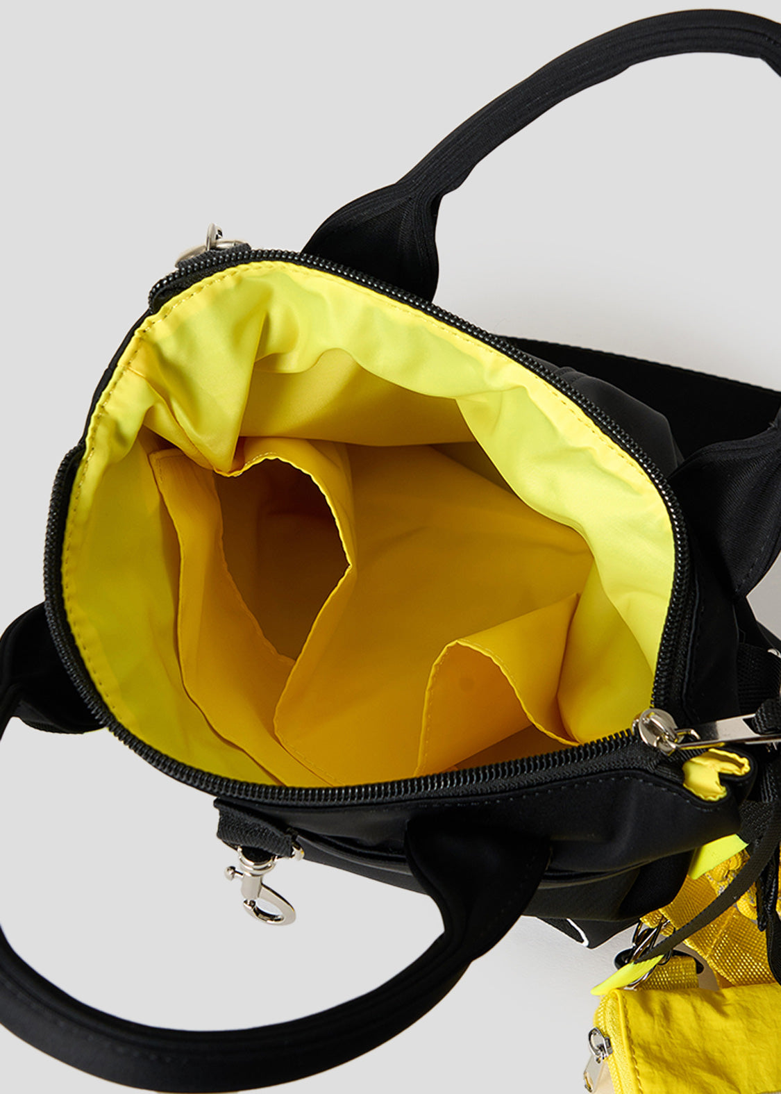 Via Artists Beautiful Shadow Lucha mini shoulder bag interior showing bright yellow lining and storage pockets