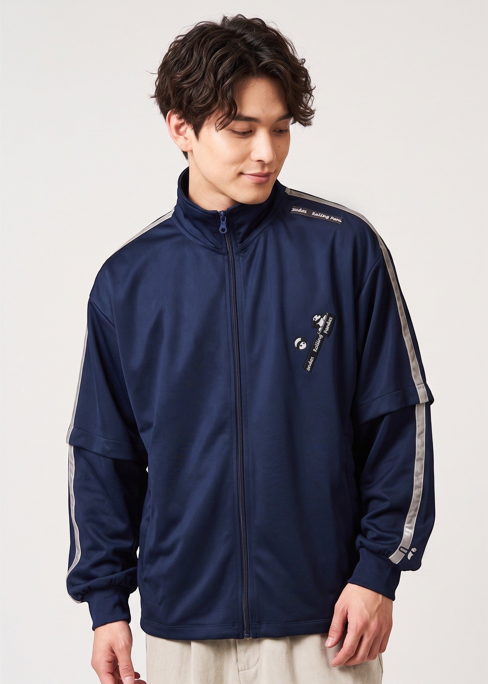 Via Artists Rolling Pandas navy blue jersey track jacket with detachable sleeves and velour tape detailing.