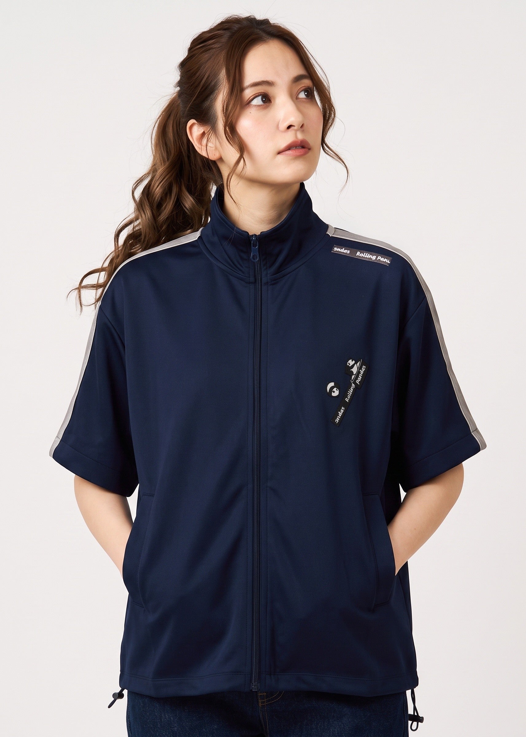 Via Artists navy blue unisex track jacket with detachable sleeves, velour tape accents, and embroidered panda design.